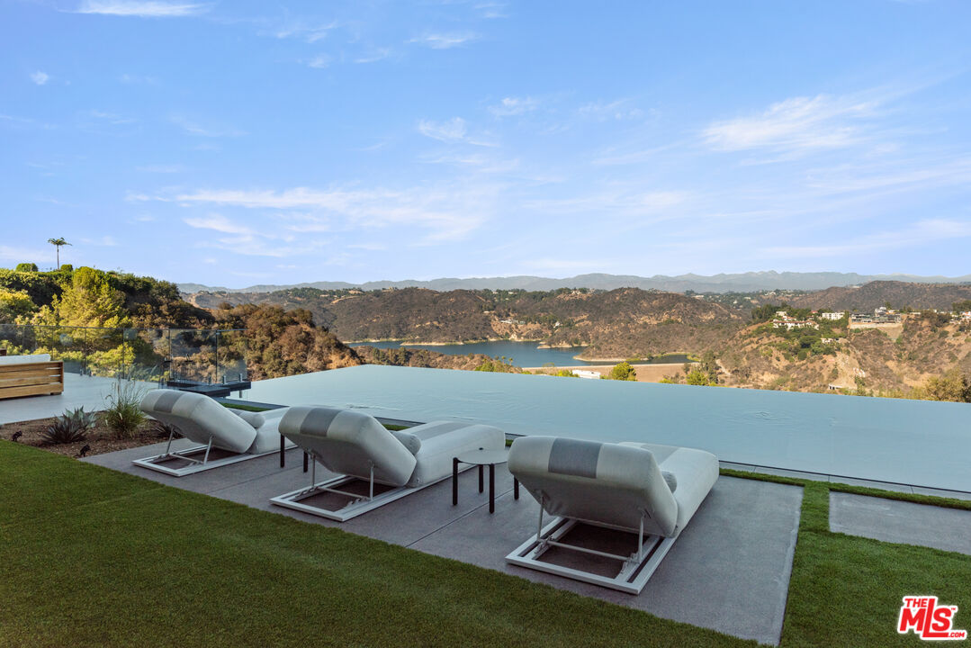 1640 Stradella Road Los Angeles, CA 90077 - Photo 21 of 25 a view of a ocean with lawn chairs and a view of city