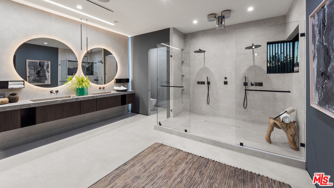 1640 Stradella Road Los Angeles, CA 90077 - Photo 10 of 25 a bathroom with double vanity sink and a mirror