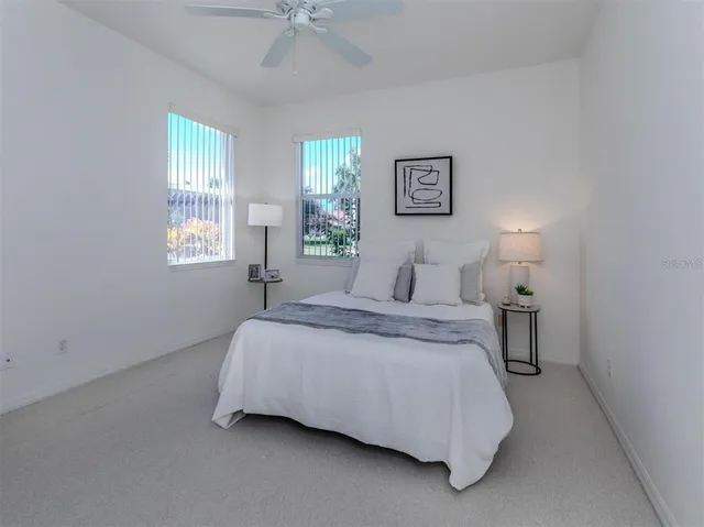 a spacious bedroom with a bed and window