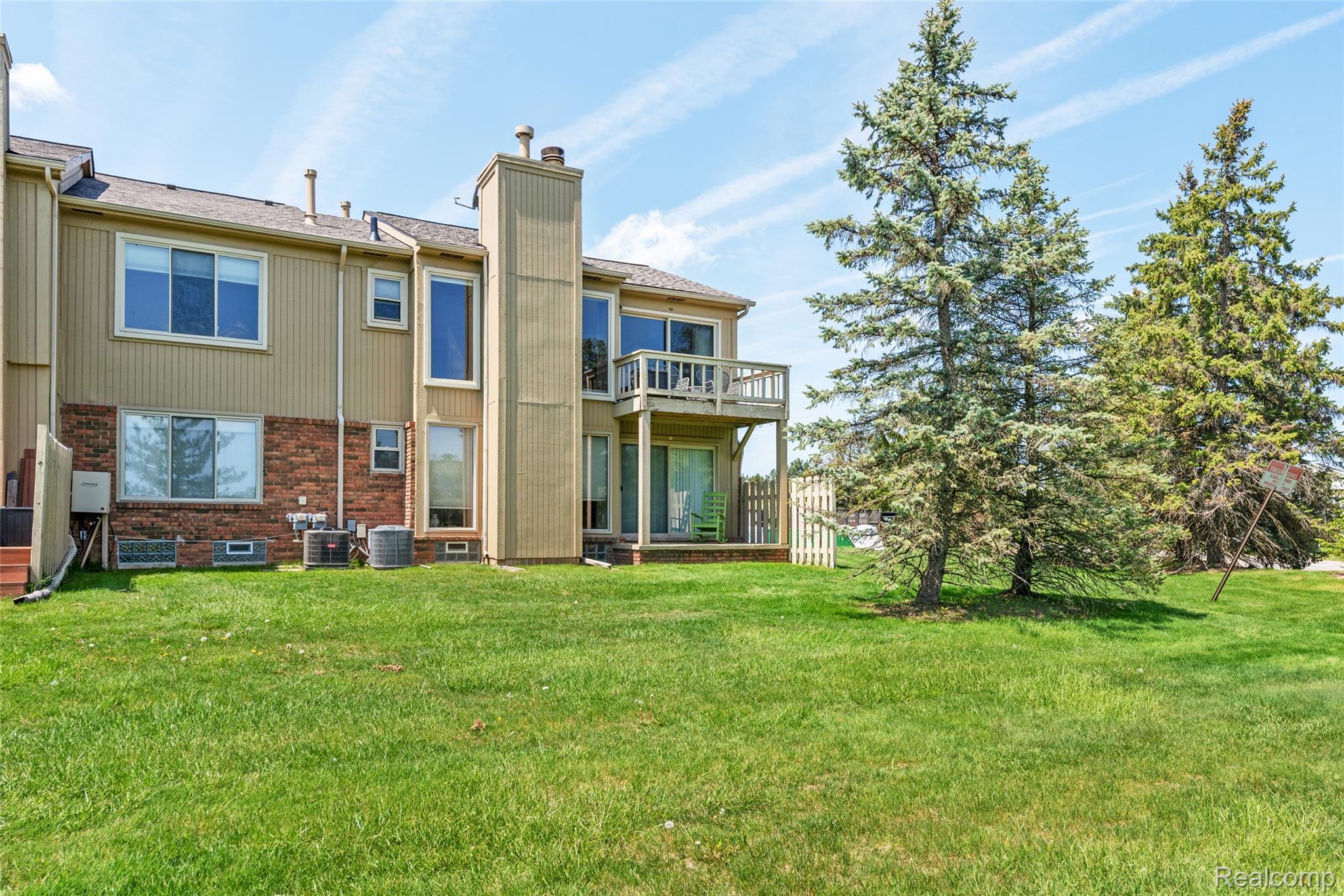 700 Tennyson Rochester, MI 48307 - Photo 24 of 32 Back of house with brick siding, a chimney, and a balcony