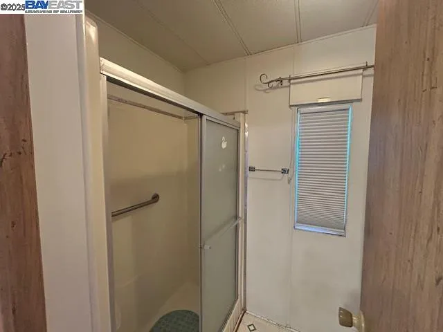 a bathroom with a glass shower door