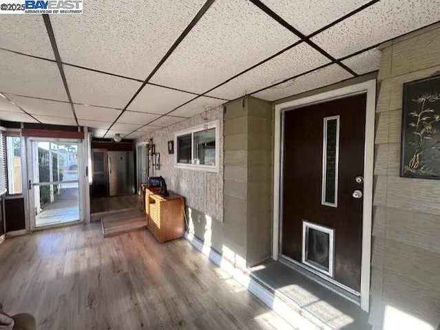 a hallway with wooden floor and furniture