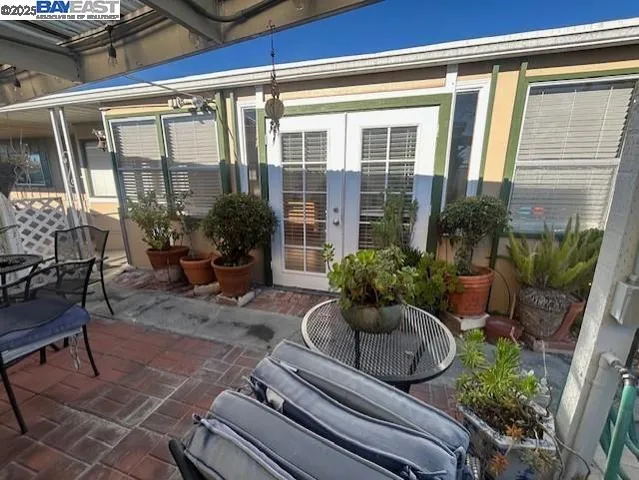 a view of a house with backyard and sitting area