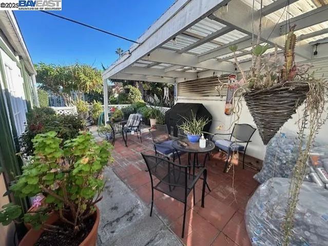 a view of a patio with table and chairs potted plants