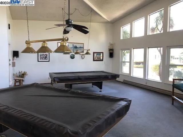 a view of a swimming pool with a patio and fire pit