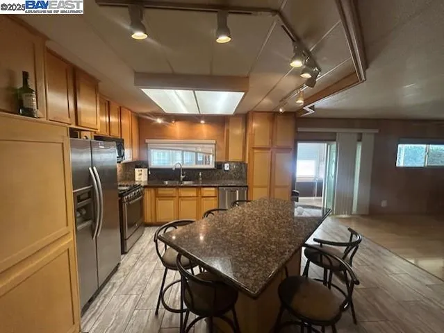 a kitchen with a table chairs refrigerator and microwave