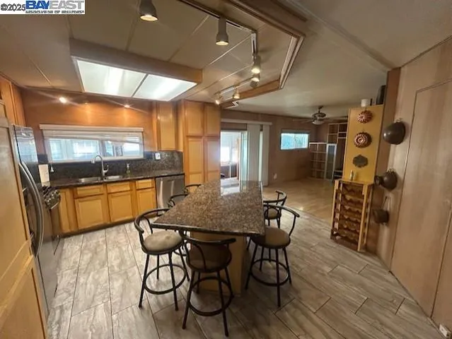 a view of a dining room with furniture and a kitchen