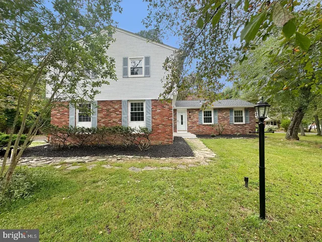 a view of a house with a yard patio and a small yard