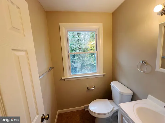 a white toilet sitting next to a bathroom sink
