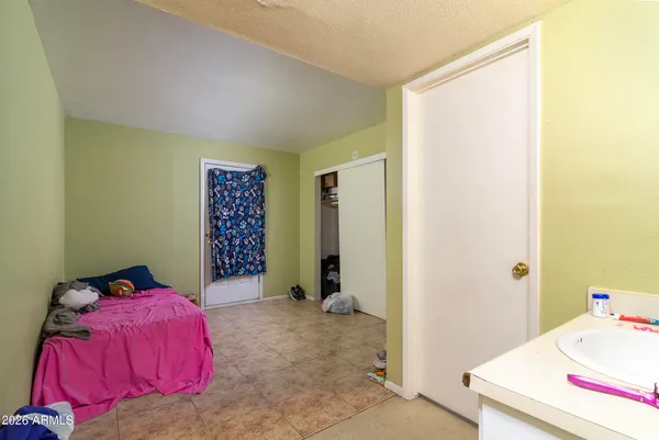 a bed room with a bed and a television
