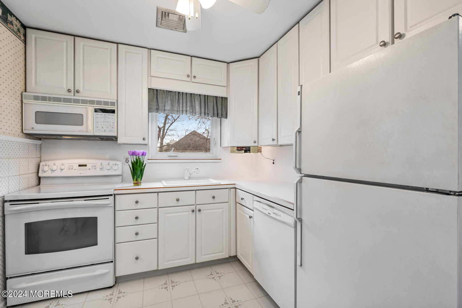 12 Bunkerhill Road Hazlet, NJ 07730 - Photo 7 of 27 a kitchen with white cabinets and white appliances