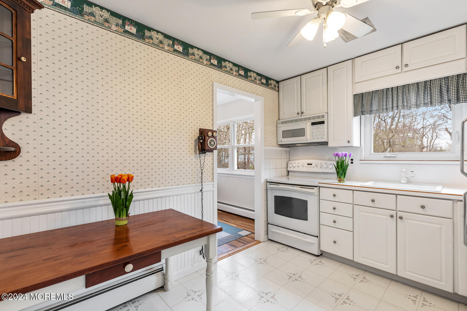 12 Bunkerhill Road Hazlet, NJ 07730 - Photo 8 of 27 a kitchen with stainless steel appliances white cabinets and wooden floor