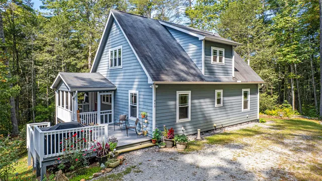 a front view of house with yard outdoor seating and yard in the back
