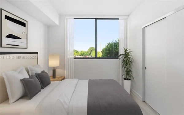 a bedroom with a bed and a window