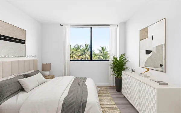 a bedroom with a large bed and a window