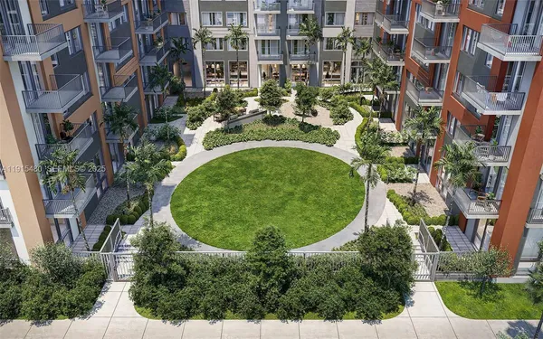 an aerial view of a house with outdoor space and trees all around