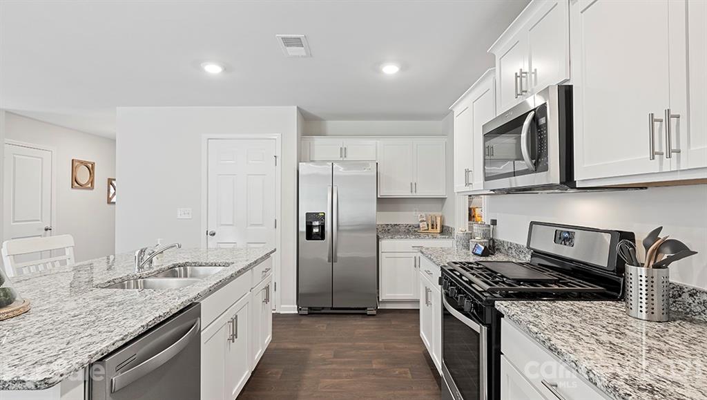 332 Gaines Road Clover, SC 29710 - Photo 13 of 32 a kitchen with stainless steel appliances granite countertop a sink stove and refrigerator
