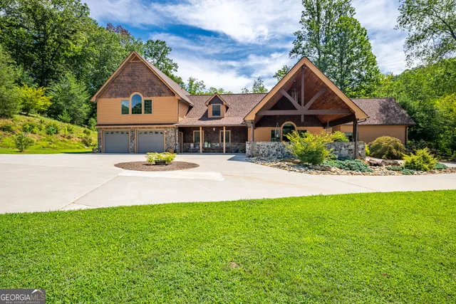 a kitchen with stainless steel appliances granite countertop a sink a counter space and a refrigerator