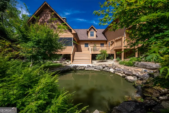 a body of water with a tree in the background