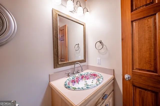 a kitchen that has a table chairs in it and wooden floors