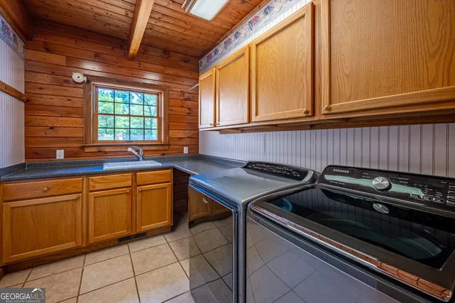 a view of a patio with table and chairs with wooden floor and fence