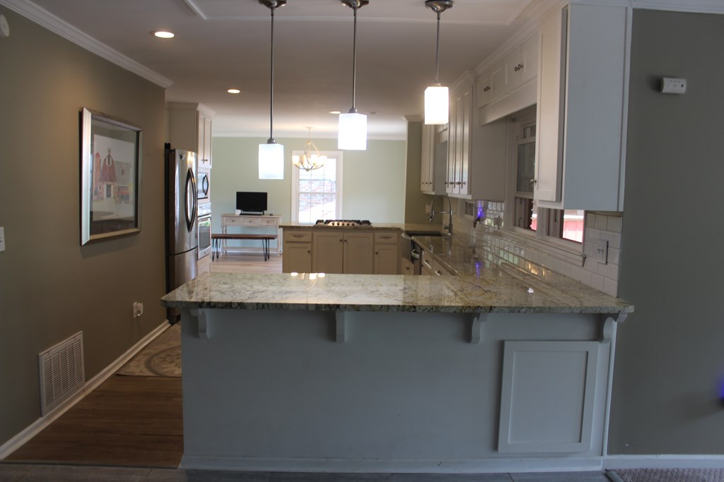 3710 Winkfield Place Columbus, GA 31909 - Photo 18 of 98 a kitchen with center island a sink stainless steel appliances and cabinets