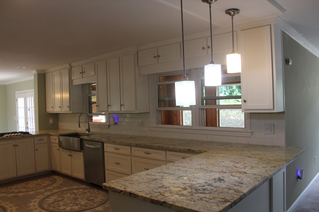 3710 Winkfield Place Columbus, GA 31909 - Photo 19 of 98 a kitchen with kitchen island granite countertop a sink a counter top space and cabinets