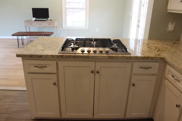 a view of a dining room with furniture and chandelier fan