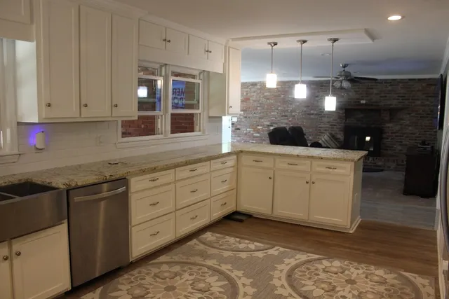 a bathroom with a granite countertop toilet sink and mirror