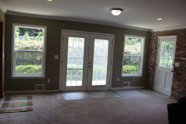 a view of walk in closet with empty racks