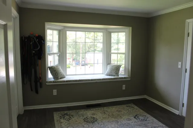 a front view of a house with yard and green space