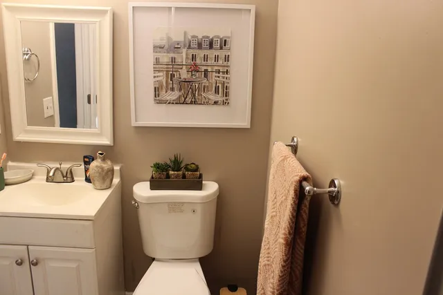 a bedroom with a bed and large windows