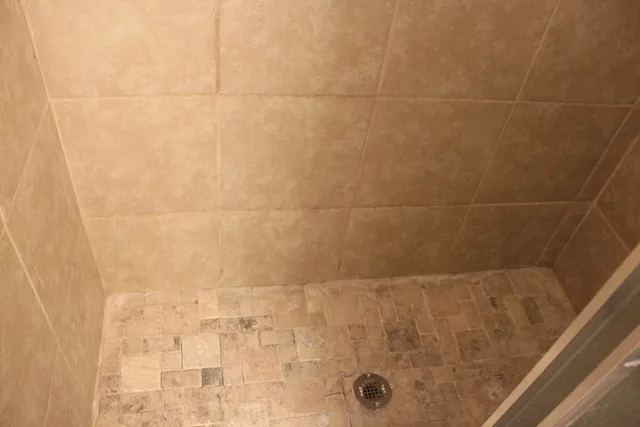 a bedroom with a bed and a mirror