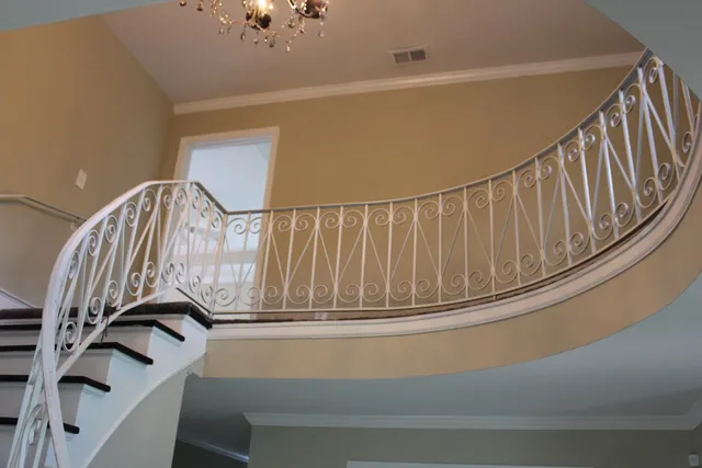 a view of a big room with wooden floor and windows