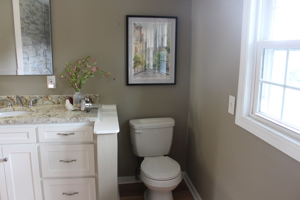 3710 Winkfield Place Columbus, GA 31909 - Photo 50 of 98 a bathroom with a granite countertop toilet sink and mirror
