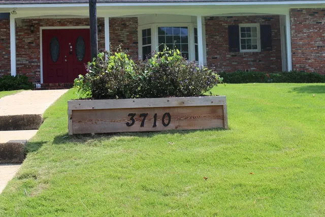 a kitchen with a sink chandelier and wooden floor