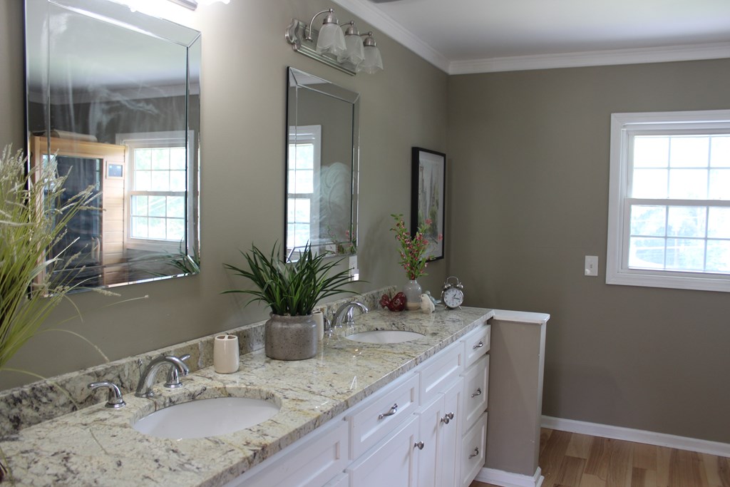 3710 Winkfield Place Columbus, GA 31909 - Photo 54 of 98 a bathroom with a granite countertop sink a large mirror and a window