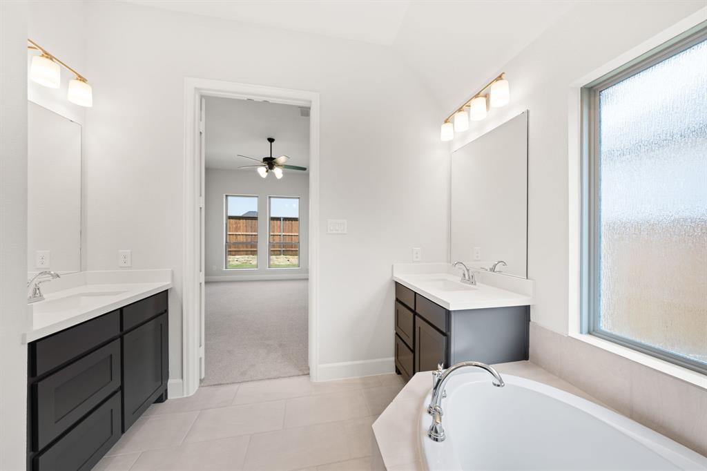 721 Running Iron Trail Mansfield, TX 76063 - Photo 13 of 23 a en suite bathroom with a toilet sink and mirror