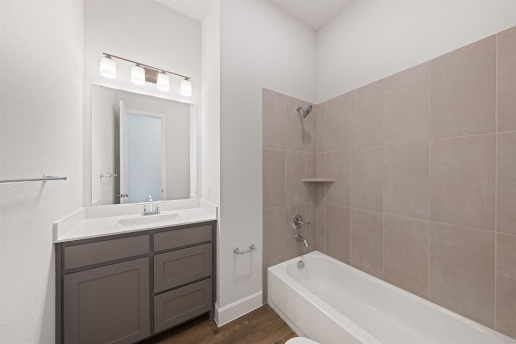 721 Running Iron Trail Mansfield, TX 76063 - Photo 15 of 23 a bathroom with a sink a toilet and shower