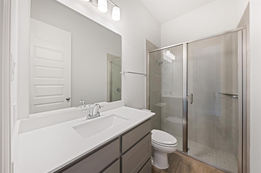 721 Running Iron Trail Mansfield, TX 76063 - Photo 16 of 23 a bathroom with a sink toilet and shower