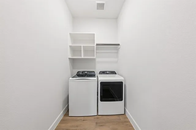 a view of a small space with wooden floor and a window