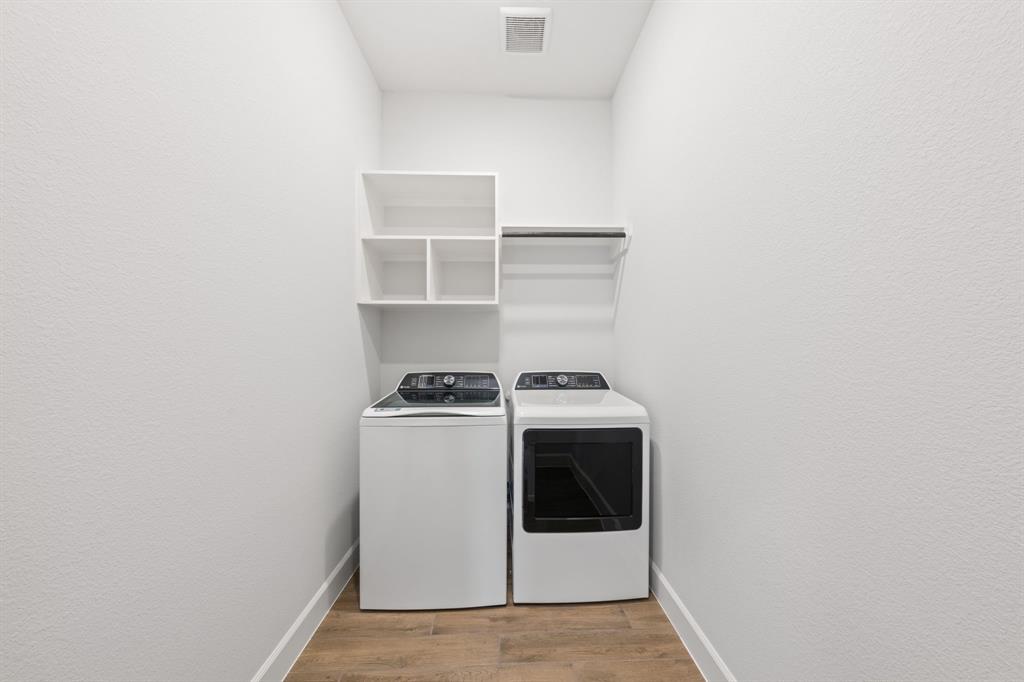 721 Running Iron Trail Mansfield, TX 76063 - Photo 18 of 23 a utility room with dryer and washer