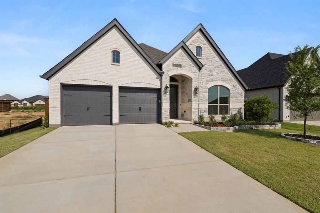 721 Running Iron Trail Mansfield, TX 76063 - Photo 3 of 23 a view of a white house with a yard and large trees