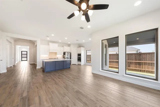 a view of a kitchen with a sink and wooden floor
