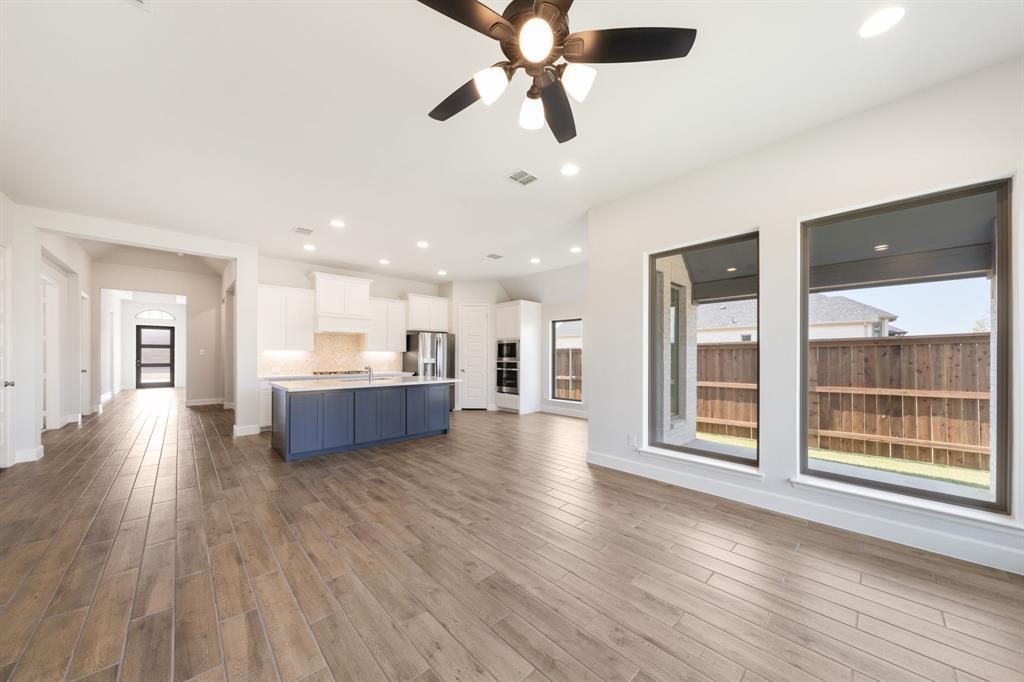 721 Running Iron Trail Mansfield, TX 76063 - Photo 4 of 23 a view of a kitchen with a sink and wooden floor