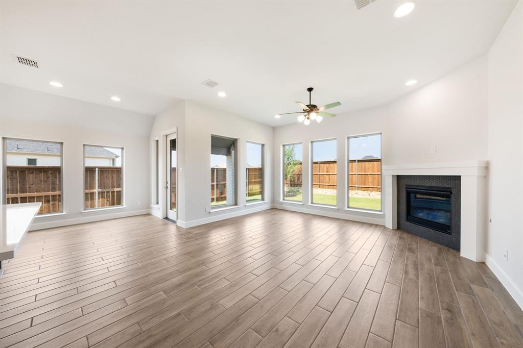 721 Running Iron Trail Mansfield, TX 76063 - Photo 6 of 23 a view of an empty room with wooden floor and a window