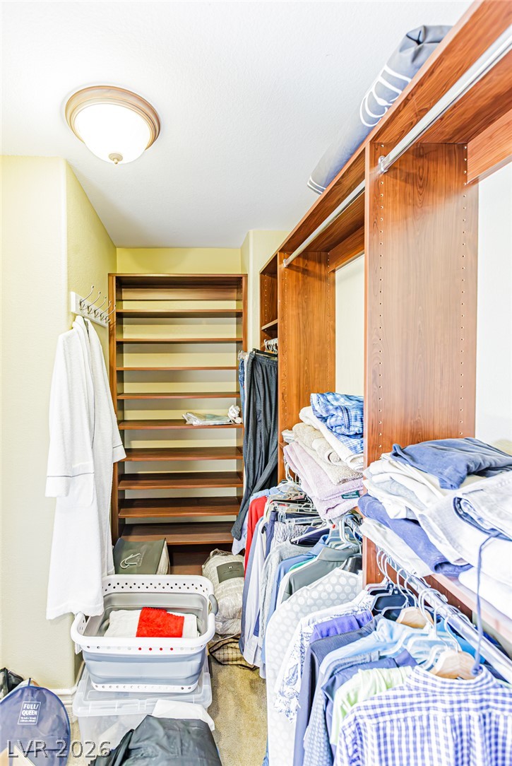 75 Tall Ruff Drive Las Vegas, NV 89148 - Photo 44 of 64 Rich wood shelving and ample hanging rods maximize organization in this functional storage area.
