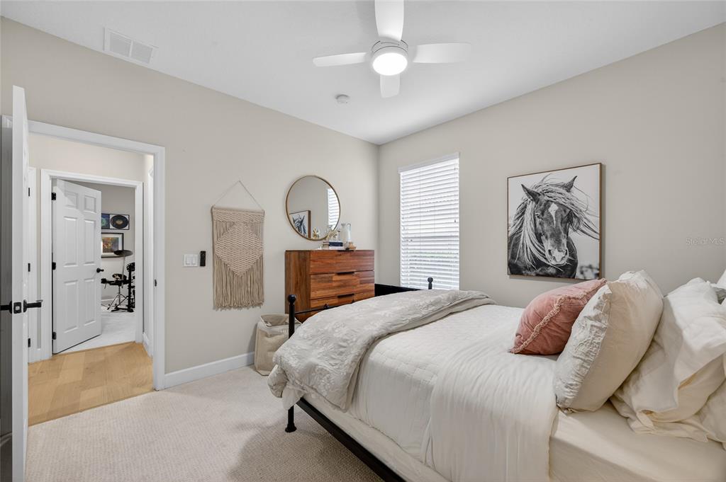 11550 Delwick Drive Windermere, FL 34786 - Photo 30 of 91 a bedroom with a large bed and a chandelier