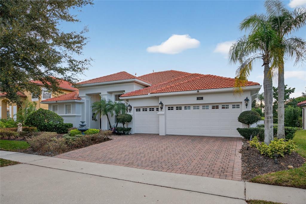 11550 Delwick Drive Windermere, FL 34786 - Photo 6 of 91 a front view of a house with a yard and palm tree