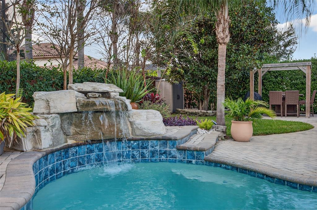 11550 Delwick Drive Windermere, FL 34786 - Photo 70 of 91 a view of a patio with table and chairs potted plants and large tree